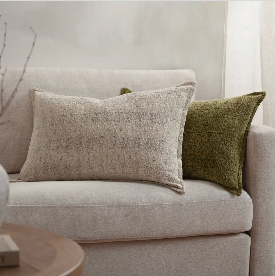 Ashby jacquard cushion styled on a cream sofa